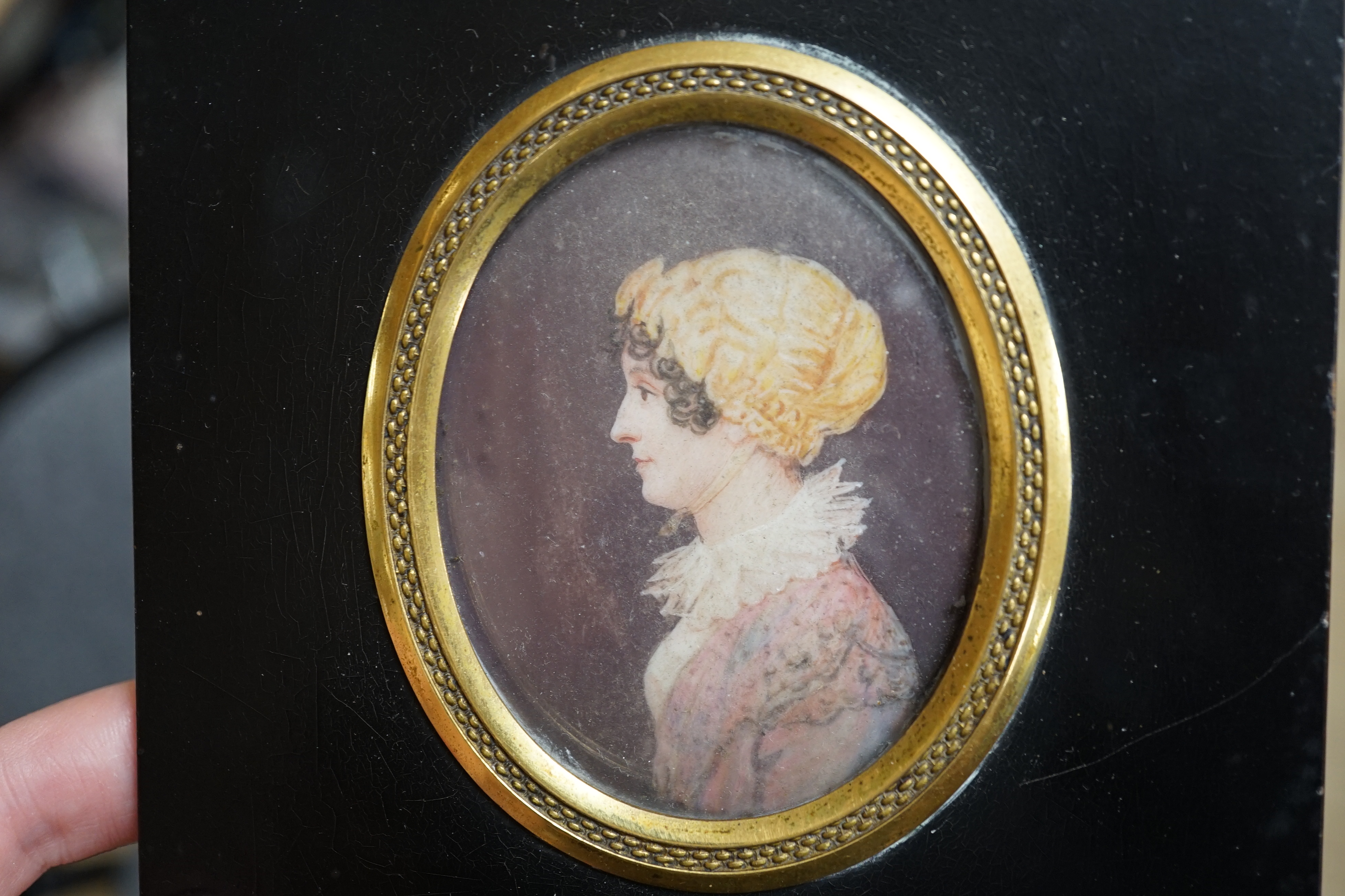 J.T. Mitchell (19th. C), set of four family portrait miniatures on ivory, including a gentleman wearing military uniform, various ink inscriptions verso, 7 x 5cm. CITES Submission reference SG9FKQRE. Condition - fair